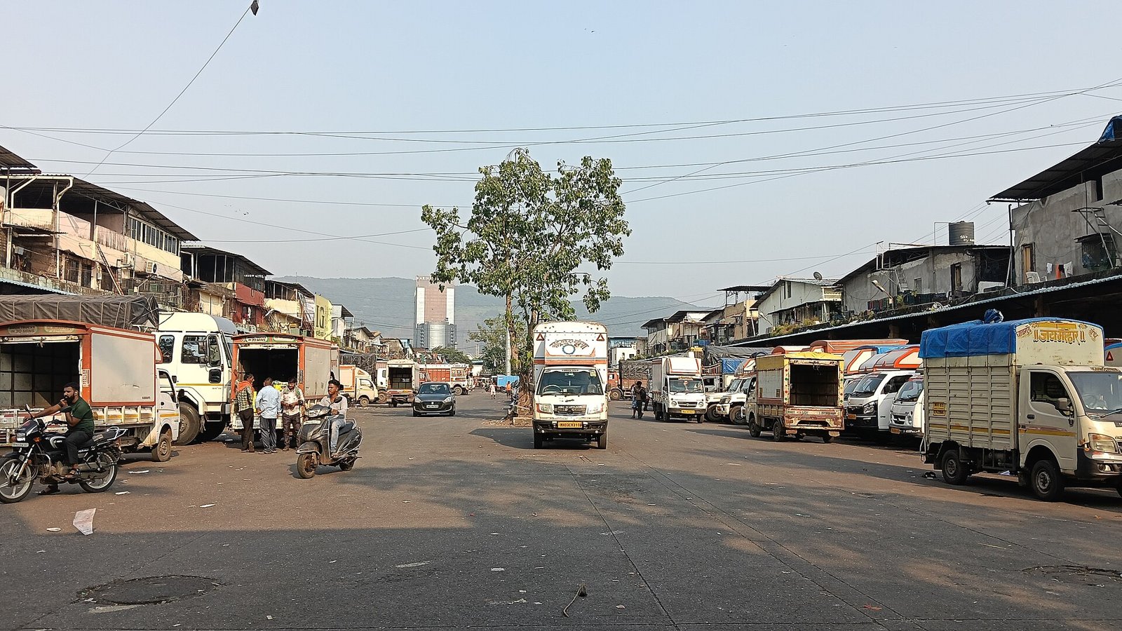 Trucks and traders in a lane of the fruit market at APMC, Turbhe