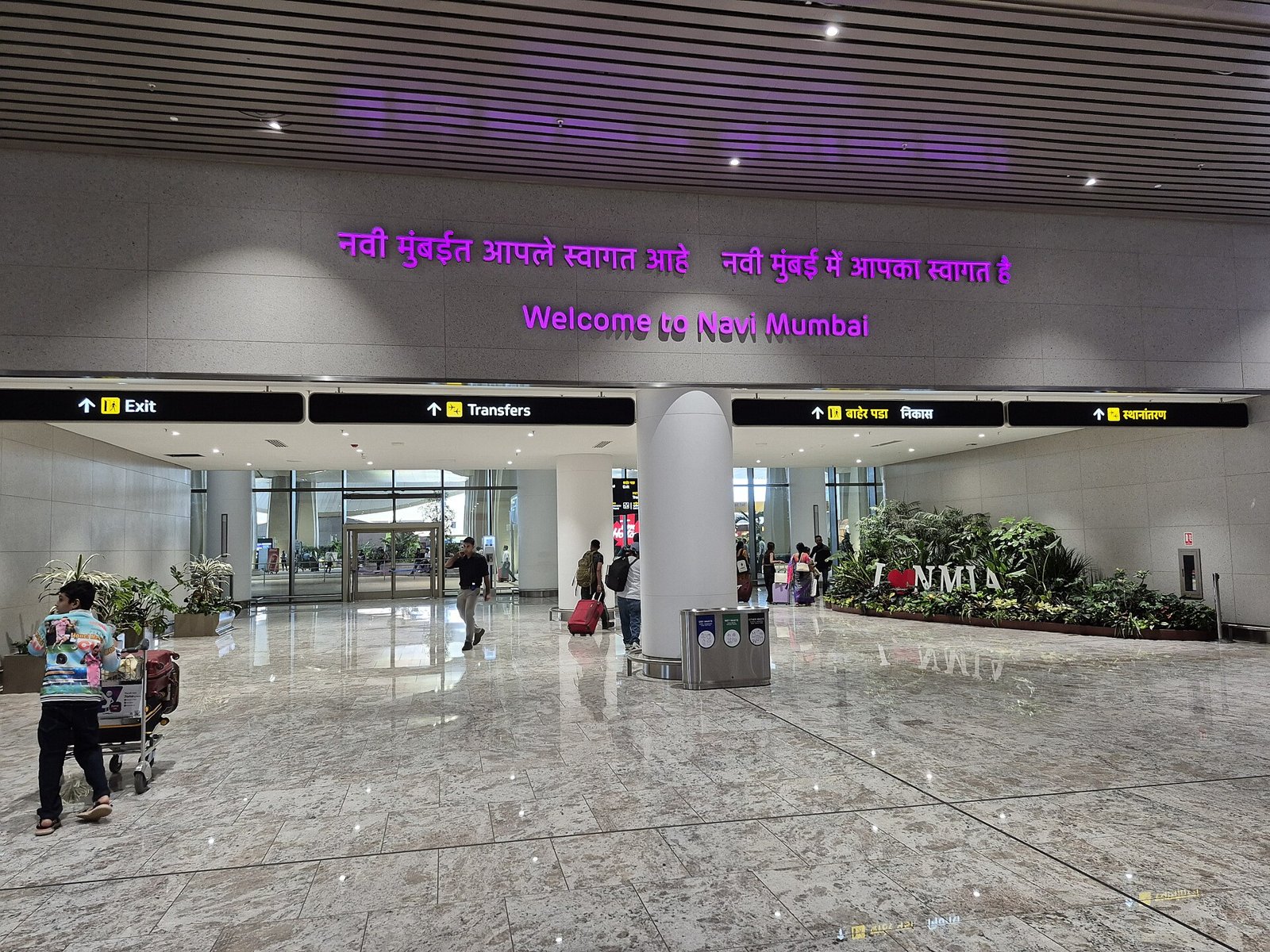 Arrivals hall at Navi Mumbai International Airport with a welcome sign in Marathi and English