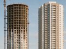 A half built tower beside a completed apartment tower
