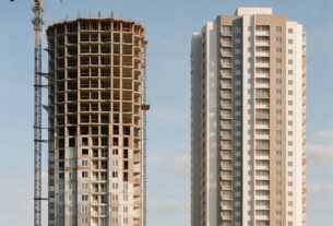 A half built tower beside a completed apartment tower