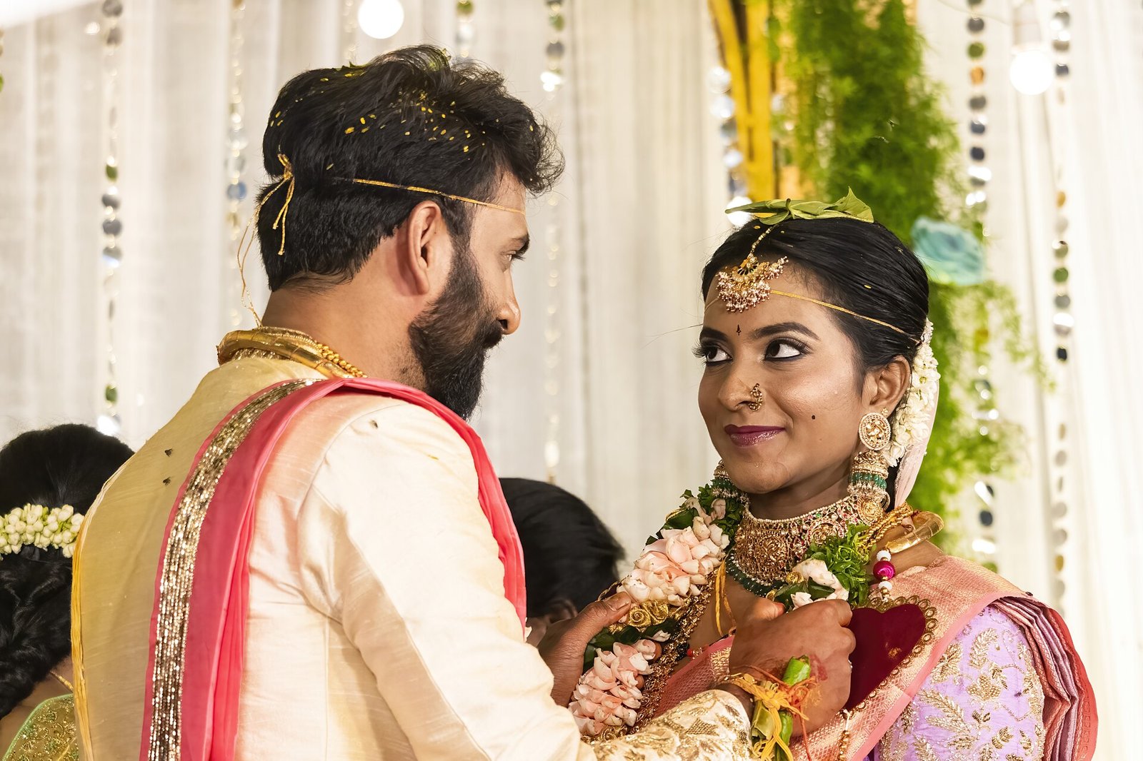 A bride and groom exchanging flower garlands during a wedding ceremony